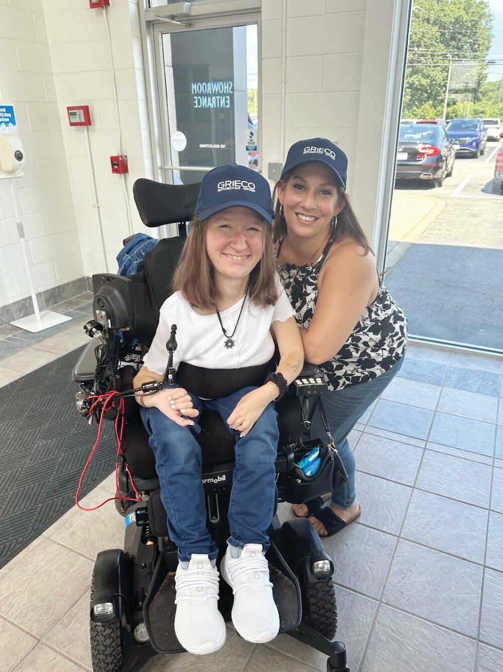GRATEFUL GUESTS: Ciarra Muller waited inside Grieco Honda’s two-story showroom, with her mother, Lacie Messier. Muller was set to start as a freshman at Community College of Rhode Island, earlier this week. Grieco Auto Group presented her family with a Honda Odyssey EX, fully equipped to accommodate a wheelchair.
